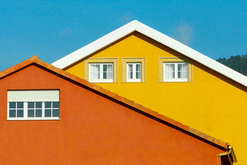 Multi colored party walls, rooftops, clear sky. Architecture, abstract view suitable for background purposes. A Coruña province, Galicia, Spain.