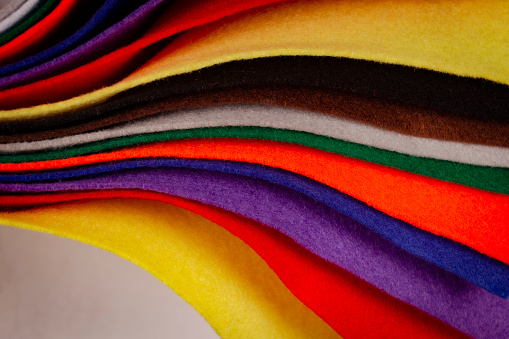 Several colored felt texture background. Assorted color felt fabric sheets, patchwork, sewing DIY craft