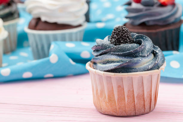 istock Cupcakes decorated with sprinkles and frosting - close up 1429383686