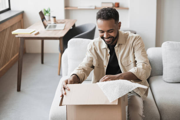istock Happy man opening parcel. Delivery concept 1429384980