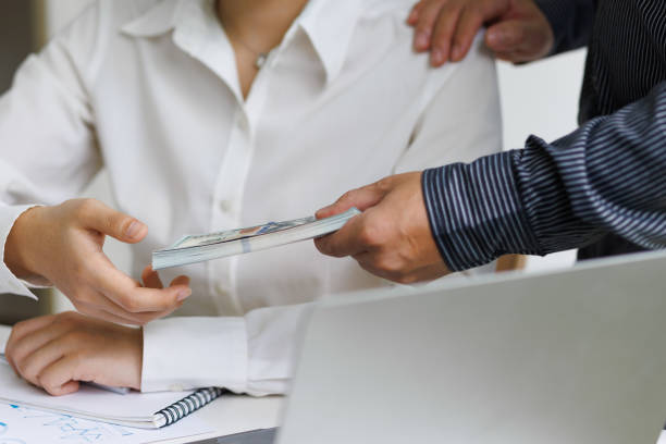 istock Businessman giving wages to colleagues. 1429387310