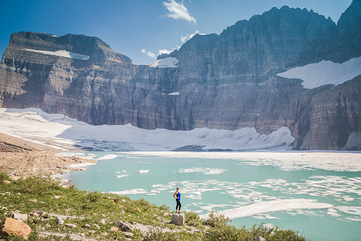 Grinnell Glacier sits above Upper Grinnell Lake in a large bowl.
