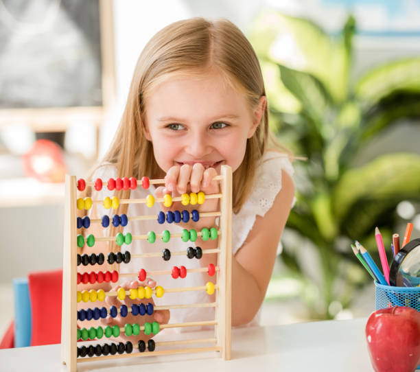 istock Little counting on the colourful abacus in the school classroom 1429406182