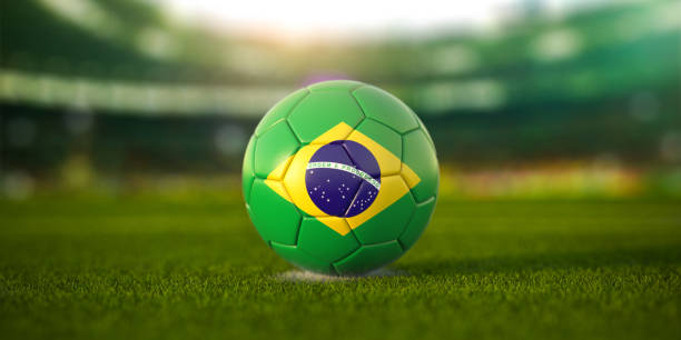 Football ball with flag of Brazil on the field of football stadium stock photo