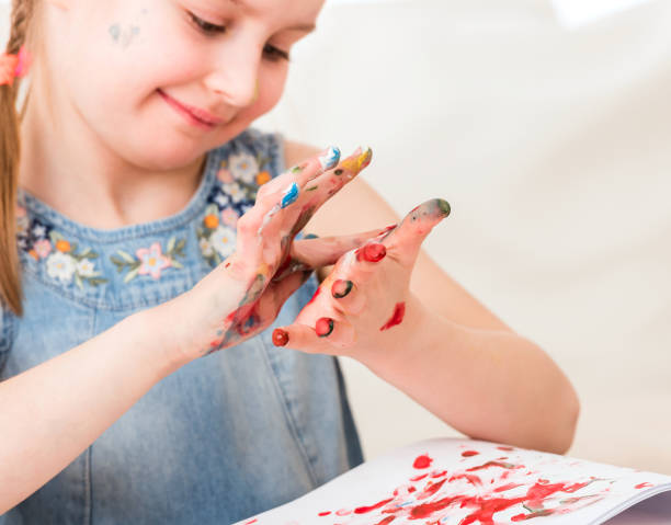 istock Child mixing colors at her hands 1429413710