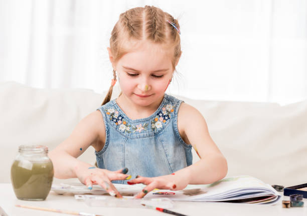 istock Kid is working with watercolor paint 1429413712