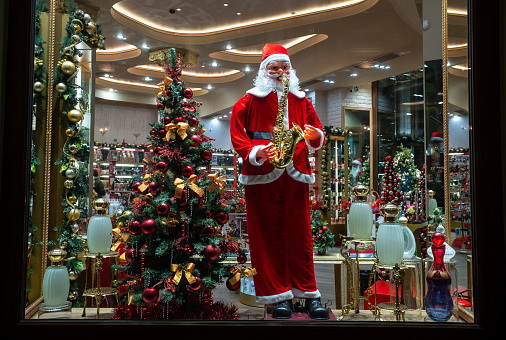 November 22, 2021, Moscow, Russia. Santa Claus is playing the saxophone in the window of a souvenir shop.