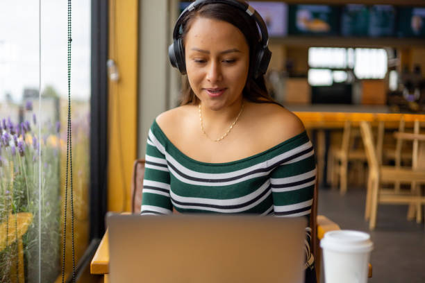 istock Young woman using her devices in a coffeeshop 1429416670