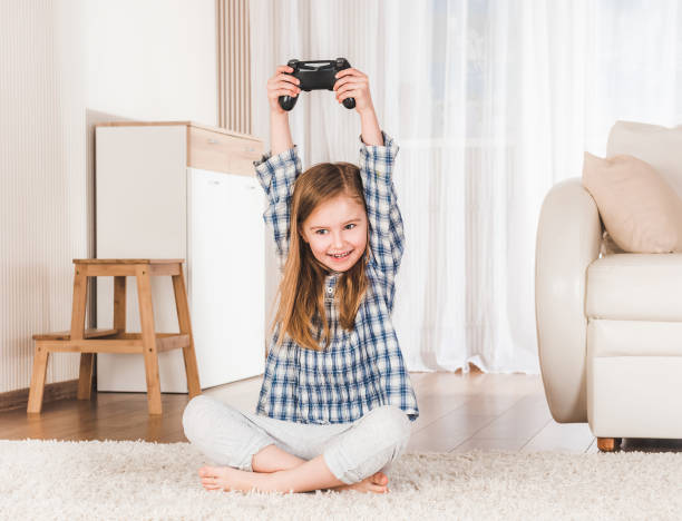 istock Lttle girl joyfully holding joystick 1429418020