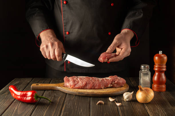 istock The chef cuts beef raw meat on a cutting board before barbecue. Asian cuisine. Preparing a delicious meal in the kitchen 1429419731