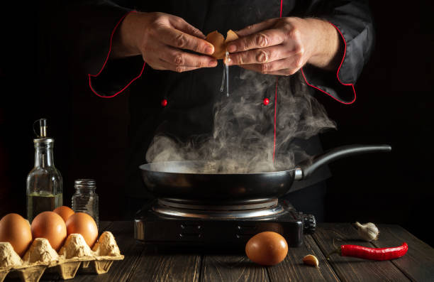 istock Cooking an egg dish or an omelet. A novice chef is practicing in the kitchen of a restaurant 1429421713
