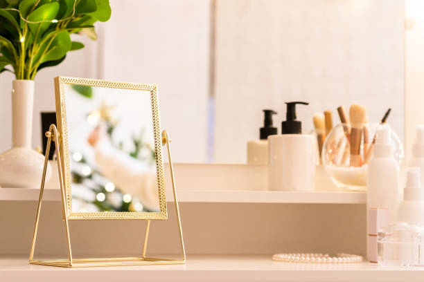 istock Reflection of christmas tree, light bulbs, in table mirror on woman dressing table with make up accessories 1429425217