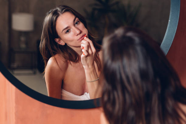 istock Young woman brushing her teeth in front of the mirror 1429431018