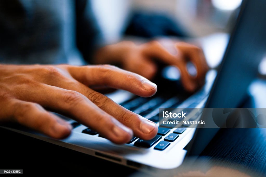 Close up man hands typing on a computer laptop keyboard Businessman or student using laptop Web Page Stock Photo