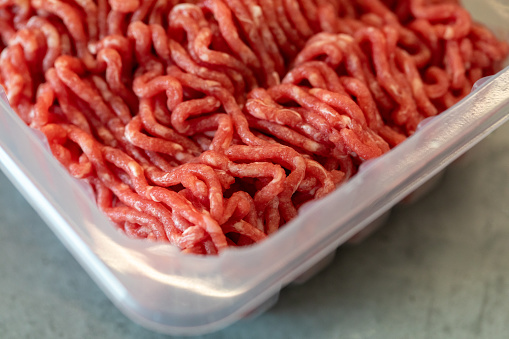 Fresh ground beef in clear plastic container