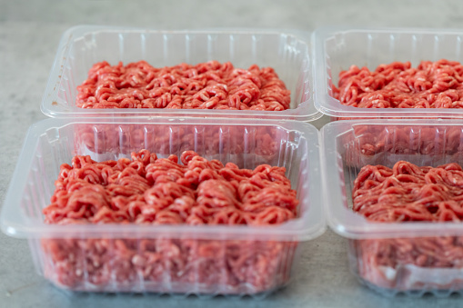 Fresh ground beef in clear plastic container