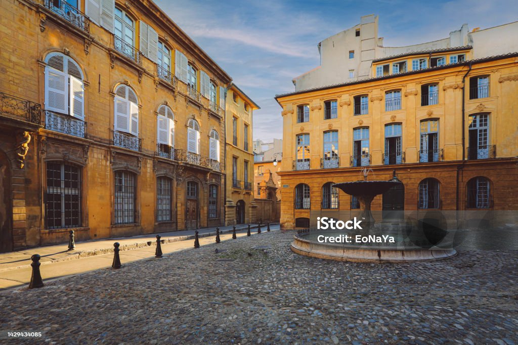 typical city Aix en Provence with old house facade View of provence typical city Aix en Provence with old house facade and famous old fountain in the morning Marseille Stock Photo