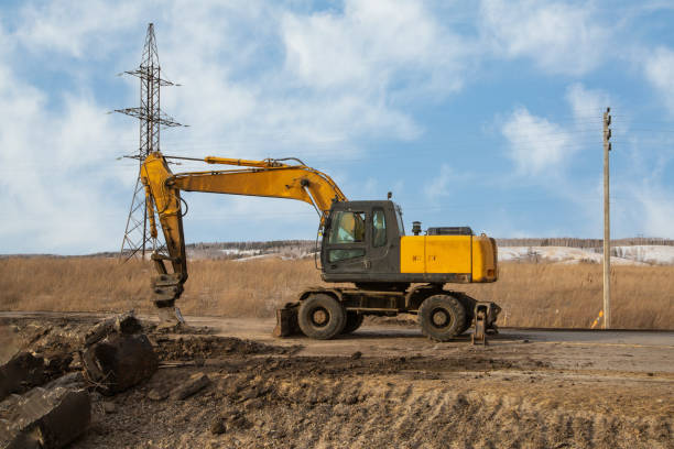 istock A working excavator with attachments on the construction of a road junction. 1429434135