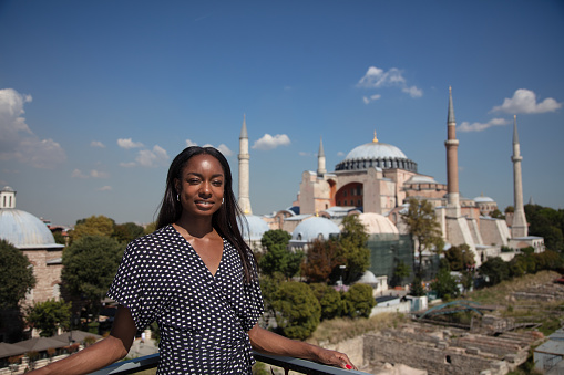 An African American woman visiting Hagia Sophia which is one of the oldest historical buildings in Istanbul and has been UNESCO World Heritage Site since 1985.