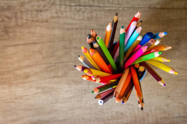 istock Various colored pencils standing in grilled pencil cup isolated on table from above 1429440904