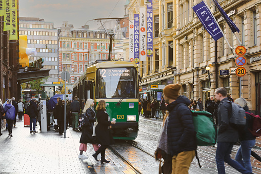 Helsinki, Finland - October 5, 2019 : green tram transporting people in the central part of the Helsinki city, Finland