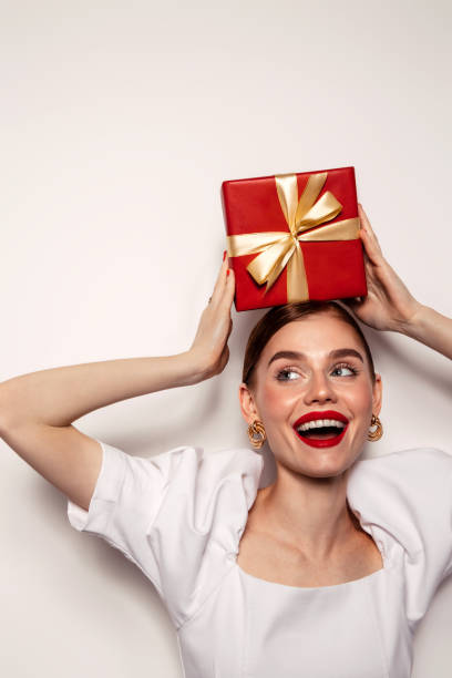 istock Beautiful emotional woman holding present box 1429447413