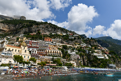 Positano, Italy - Aug 25, 2021: Panoramic view of Positano and the beach along the Amalfi Coast of Italy.