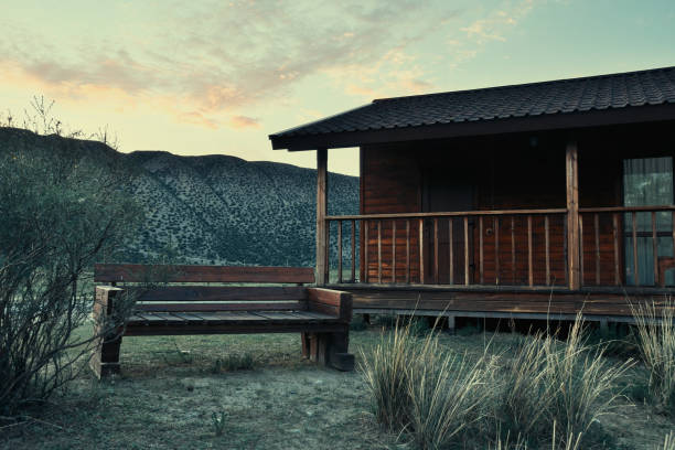 istock Lonely rural hut and bench in the steppe with mountains 1429451112