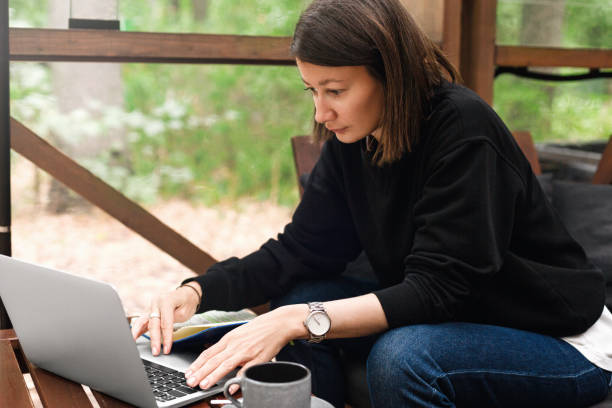 istock Woman drinking coffee and using laptop at cafe 1429451142