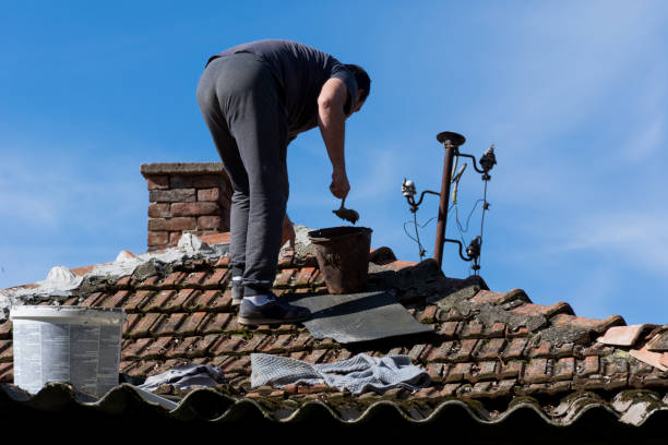 istock Man standing on roof and fixing damaged tiles with cement 1429459436