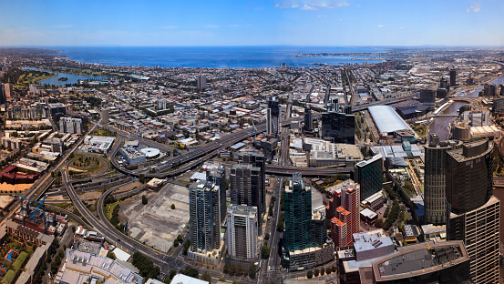 City of Melbourne cityscape panorama to Port Phillip bay port and waterfront from elevation of downtown high-rise tower.