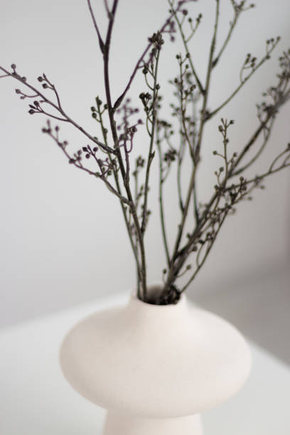 istock White vase on a white table with twigs. 1429472066