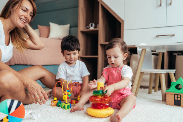 istock Mother playing with toddlers 1429477556