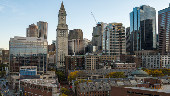 Boston downtown skyline with famous historic buildings as: Custom House Clock Tower and Faneuil Hall.