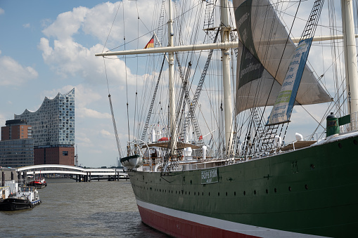 Hamburg, Germany - June 25, 2022: Side of the Rickmer Rickmers, a museum ship in the Port of Hamburg, with the Elbphilharmonie concert hall in the background.