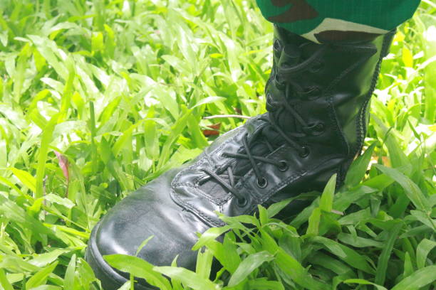 istock soldier's right shoe on green grass 1429487457