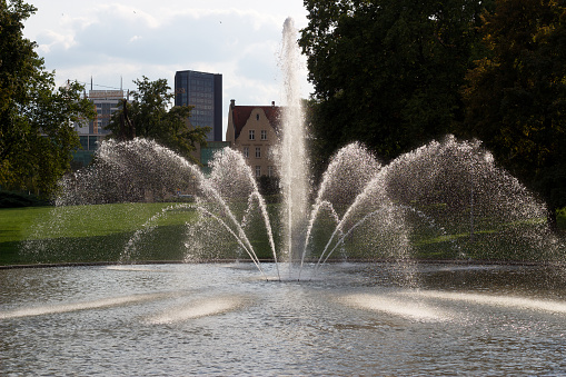Fountain in the city center. A working fountain with water splashes.