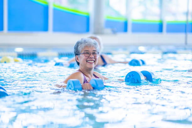 istock Seniors Lifting Weights in a Pool 1429492745