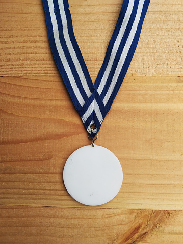 achievement medal on a wooden background