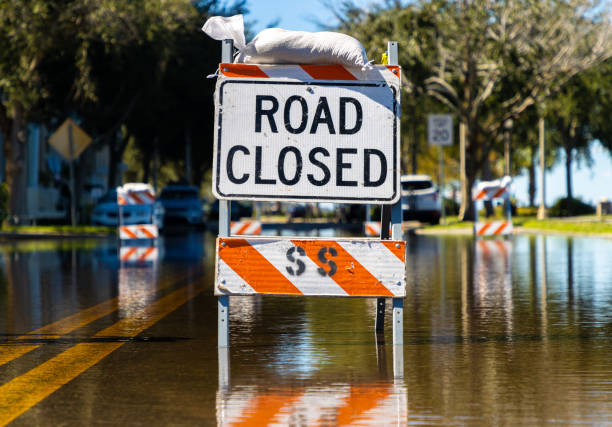 istock Road closed barrier on flooded street 1429506830