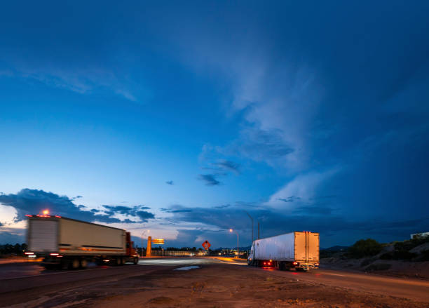 istock Trucks driving fast on the highway at blue hour 1429515076