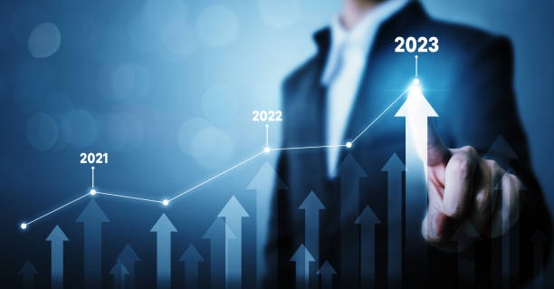Businessman pointing arrow graph corporate future growth plan. Business development to success and growing growth year 2022 to 2023 concept stock photo