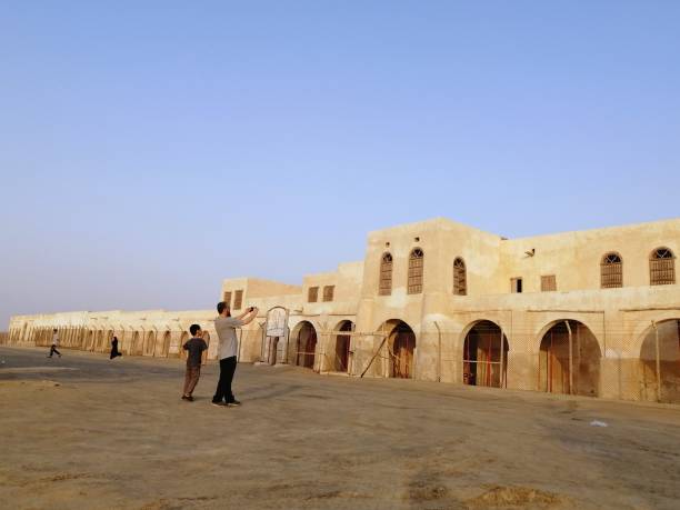 Father and son enjoy visiting old historical building which is Port of Uqair- Saudi Arabia, the first seaport in Persian gulf.