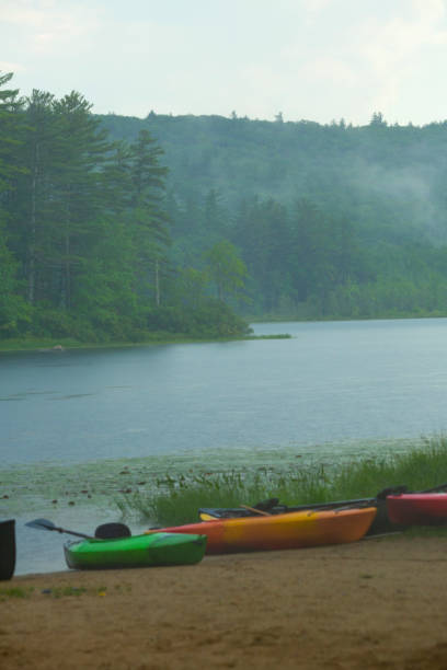 istock Summer shower with kayaks on the beach at Beaver Pond. 1429544927