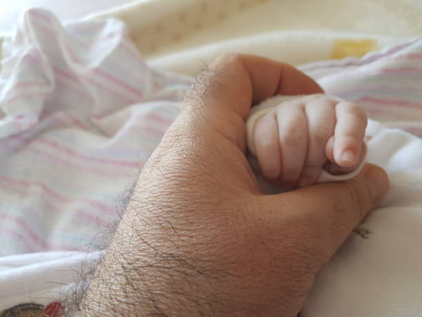 istock baby and father hand hands holding each other 1429544962
