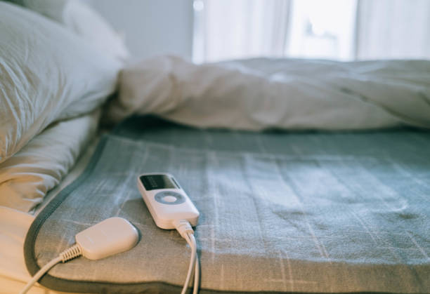 Using Electric Blanket In Winter During Energy Crisis Stock Photo