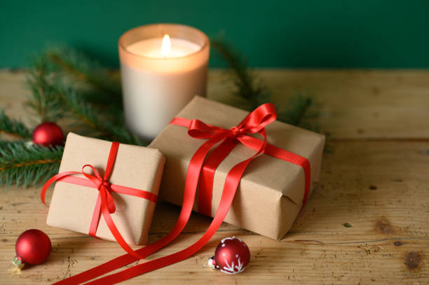 istock Christmas presents with ornaments on table with candle light 1429547650