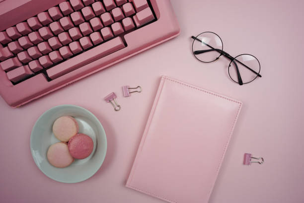 istock On the pink table there is a pink retro typewriter and there is a notebook for notes. 1429549351