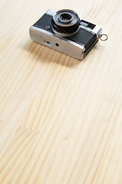 retro film camera placed on wooden table