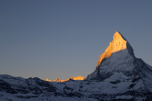 Mountain climbing route displayed as a map diagram with waypoints aiming to the peak, marked by a flag. Artist rendering of a fictitious ascent. Background image shot on Italian Alps.